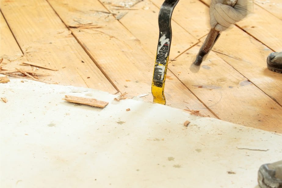 Removing engineered hardwood using crowbar